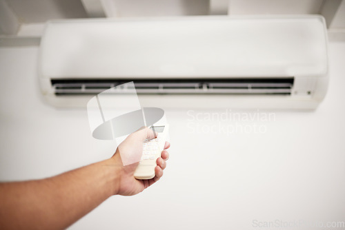 Image of Air conditioner, hand and remote for electrical machine check with person in a home with ac repair. Maintenance, and system control for installation, inspection of aircon fix in house with contractor