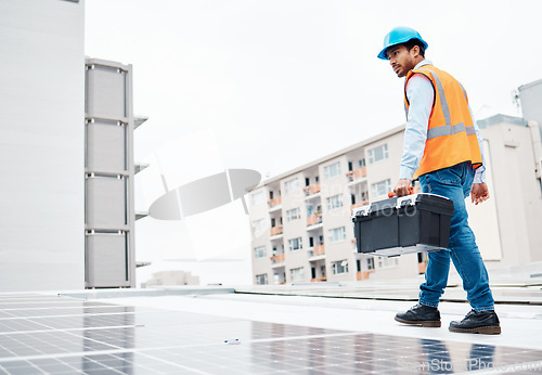 Image of Solar panel, tool box and engineering with man on roof top for renewable energy, project or power. Construction, electricity or technician with contractor in city for inspection and photovoltaic grid