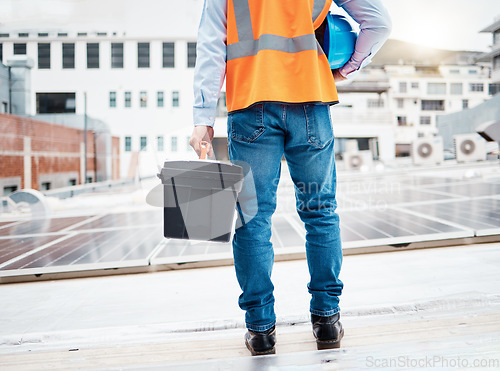 Image of Tool box, construction worker and back with solar panel maintenance and labor outdoor. Roof, eco engineer and green energy project with builder and sustainability contractor with building project