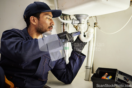 Image of Plumbing, pipes and maintenance with man in kitchen for repair, industrial and inspection. Handyman, tools and safety with male plumber fixing sink for home improvement, drainage and water system