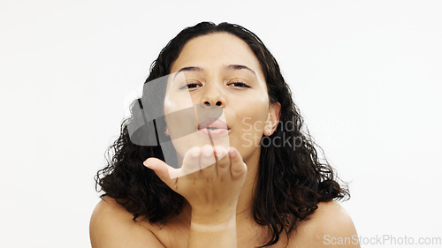 Image of Skincare, happy and portrait of a woman blowing kiss isolated on a white background in a studio. Flirty, happiness and a girl with affection, flirtatious smile and gesture of love on a backdrop