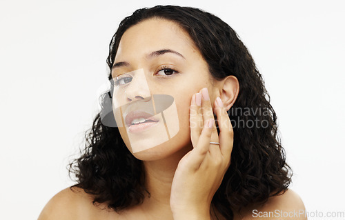 Image of Face, beauty and makeup with a woman in studio isolated on a white background touching her skin. Portrait, skincare and facial with an attractive young female rubbing her cheek for natural treatment