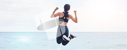 Image of Back, freedom and fitness woman jump at the beach with celebration after running, training or workout success in nature. Exercise, jumping and behind female at the sea celebrating goal milestone