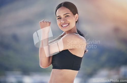 Image of Fitness, portrait and happy woman stretching arm outdoor for running, training or morning cardio routine on blurred background. Face, smile and female runner with shoulder stretch exercise or warm up