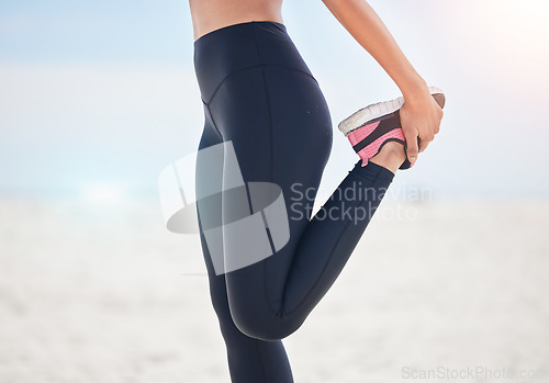 Image of Fitness, woman and stretching leg at a beach for running, workout and body, exercise or wellness routine. Foot, stretch and female runner at the sea for training, sports and physical performance