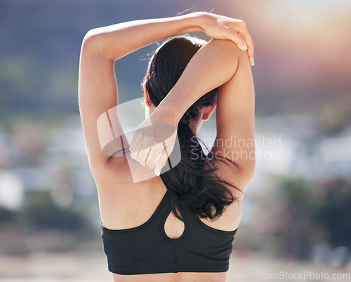 Image of Fitness, woman back and stretching arm in city for running, workout and body, exercise or wellness routine. Hands, stretch and behind lady runner outdoor for training, sports or physical performance