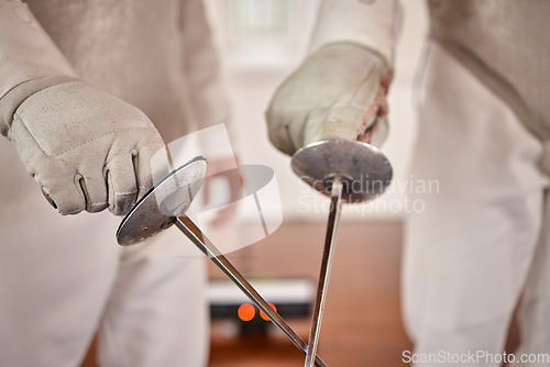 Image of Fencing, hands or fight with a sword in training, exercise or fighting workout with a weapon in sports. Martial arts, closeup or combat fighters in competition with blade for fitness or coaching