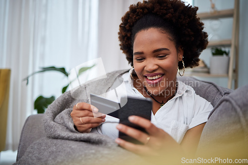 Image of Happy black woman, phone and credit card for ecommerce, payment or fintech banking on sofa at home. African female person or debit shopper on mobile smartphone app in online shopping, purchase or buy