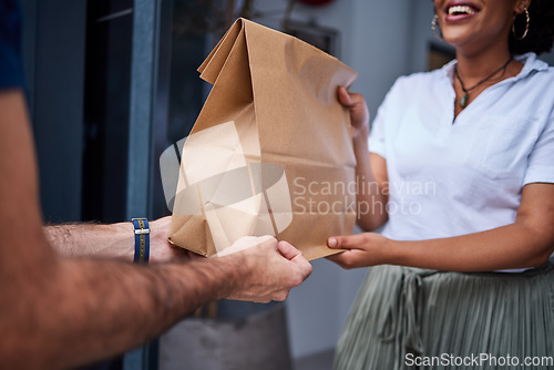 Image of Delivery, customer and hands with a paper bag at door from courier man at home. Giving woman or a client a package, parcel or fast food from online shopping, e-commerce or distribution service