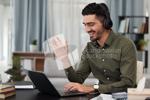 Image of Man, remote work and video call with headphones at laptop for voip communication, online meeting or telecom. Freelance virtual assistant wave at computer with microphone for consulting in home office