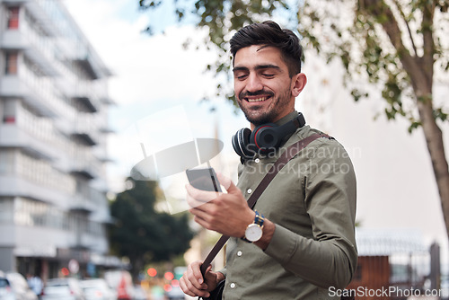 Image of Travel, city and man with a phone outdoor for communication, connection or chat. Happy male student on urban street with smartphone and network for reading social media or navigation app notification