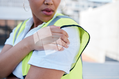 Image of Woman, engineer and hands with shoulder pain outdoor from injury, accident and muscle tension on rooftop. Closeup of female contractor with sore arm, ache and joint inflammation at construction site