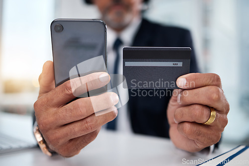 Image of Hands, phone and credit card man in office for payment, ecommerce or budget for shopping in call center. Consultant, crm and banking in closeup for loan, fintech or bills in telemarketing workplace