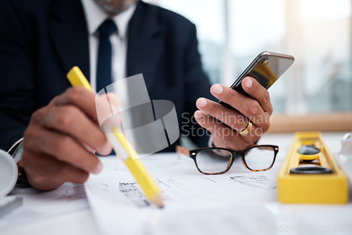 Image of Phone, hands and pencil of architect man in an office with a blueprint, drawing or floor plan project. Closeup of male engineer with building design, internet connection and sketch for construction