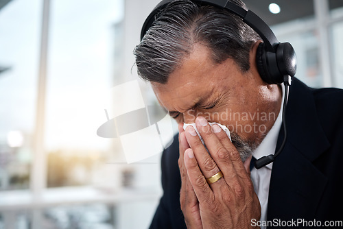 Image of Sick, man and blowing nose in call center office for flu, allergies, and health risk in telemarketing agency. Face of mature salesman, CRM agent and tissue for virus, allergy bacteria and sneeze