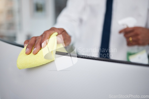 Image of Person, hands and cleaning computer with cloth in office for hygiene, health or safety of virus. Closeup of business worker wipe dirty desktop monitor for sanitation, disinfection or bacteria of dust