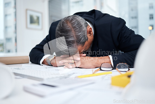 Image of Tired, exhausted and architect man in an office with a design problem, mistake or deadline for project. Mature male engineer sleeping at desk with fatigue, burnout or crisis in construction industry