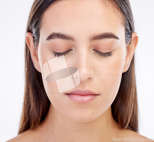 Image of Beauty, relax face and woman eyes closed for mindfulness, peace and calm after spa routine, skincare treatment or self care. Natural makeup, dermatology and closeup studio person on white background
