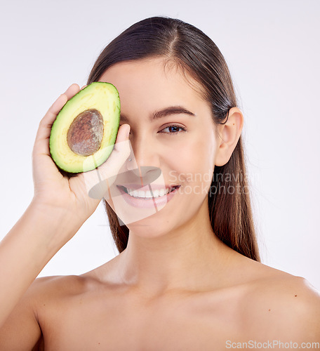 Image of Face, skincare and happy woman with avocado for beauty isolated on a white background in studio. Portrait, smile and natural model with fruit food for nutrition, healthy diet or omega 3 for wellness