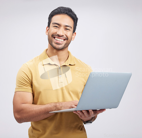 Image of Portrait, smile and man with laptop, network and internet connection on a white studio background. Male person, guy and model with a pc, website information and happiness with an email and internet