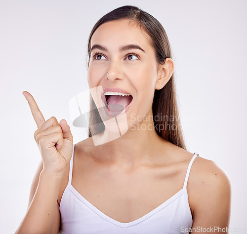 Image of Pointing, surprise and woman excited, announcement and happiness on a white studio background. Wow face, person or model with shock, hand sign and choice with ideas, promotion and news with promotion