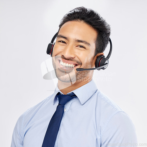 Image of Face, call center and Asian man with headphones for telemarketing, crm support and isolated on a white studio background. Portrait, smile and sales agent, consultant or customer service professional