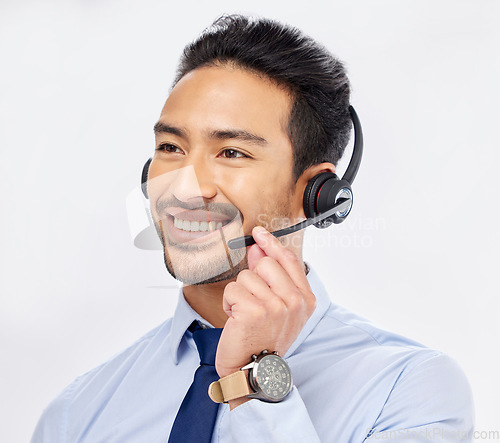 Image of Call center, happy and Asian man with microphone for telemarketing, crm support and isolated on a white studio background. Thinking, smile and sales agent or consultant listening for customer service