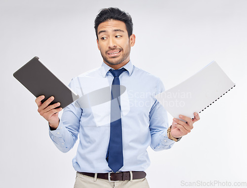 Image of Choice of print vs digital by businessman with paperwork for corporate work isolated in a studio white background. Tablet, decision and professional with document feeling confused and with question