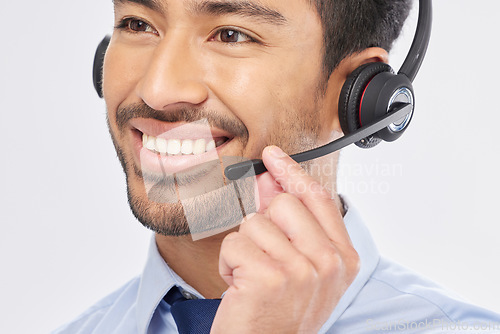 Image of Face, smile and headset with a call center man in studio on a white background for customer service or support. Contact us, crm and consulting with a happy male employee talking for assistance