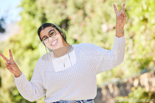 Image of Peace sign, woman and portrait with a smile outdoor of student on summer holiday and vacation. Motivation, gen z and emoji v hand gesture feeling silly with freedom and female person from Morocco