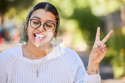 Image of Peace sign, woman and outdoor with a smile of student on summer holiday and vacation. Motivation, tongue out and emoji v hand gesture feeling silly with freedom and happy young female from Sudan