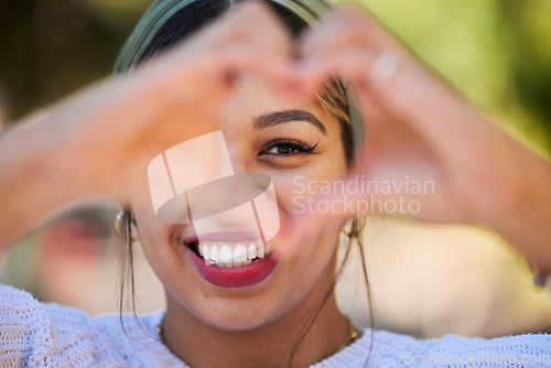 Image of Heart hands, happy and portrait of woman in park for support, health and kindness symbol. Love, emoji and motivation with person and gesture in nature for empathy, trust and valentines day icon