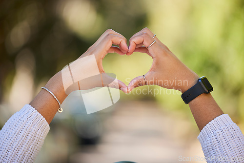 Image of Heart, love and hands of woman in park for support, health and kindness symbol. Peace, emoji and motivation with closeup of person and gesture in nature for empathy, trust and valentines day