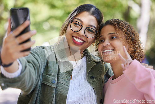 Image of Women friends, selfie and peace sign at park with smile, hug or together for memory, blog or post on web. Girl, gen z students and happy for profile picture, photography or outdoor for social network