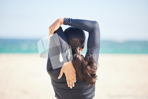 Image of Woman, fitness and stretching body on beach for exercise, workout or outdoor running. Rear view or back of female person, athlete or runner in warm up preparation or getting ready for cardio training