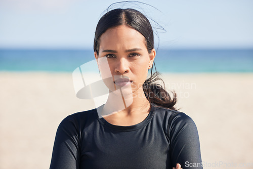 Image of Fitness, beach and portrait of serious woman by the ocean ready for surf, exercise and workout. Female person, focus and face of a athlete from Hawaii outdoor by the sea in nature with training