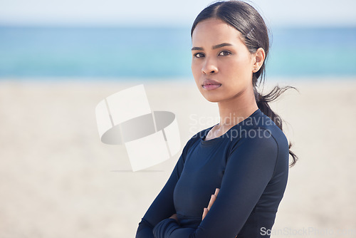 Image of Mockup space, beach and portrait of serious woman by the ocean ready for surf, exercise and workout. Female person, focus and face of a athlete from Hawaii outdoor by the sea in nature with training