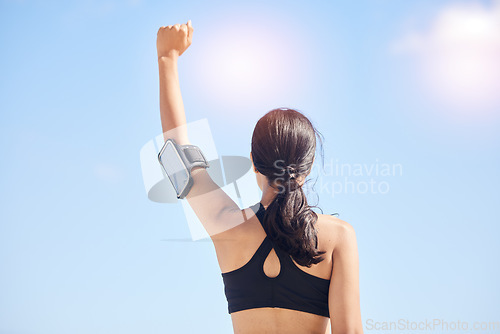 Image of Woman, fitness and fist pump in achievement for winning, workout success or outdoor exercise. Rear view of female person in celebration for accomplishment or training with sky background on mockup