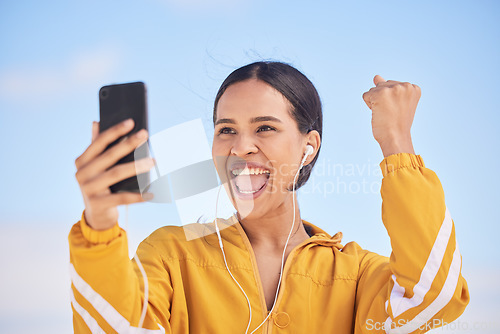 Image of Happy woman, phone and fitness winning in celebration for workout milestone or outdoor achievement. Excited female person and fist pump in happiness for exercise goals or success on mobile smartphone