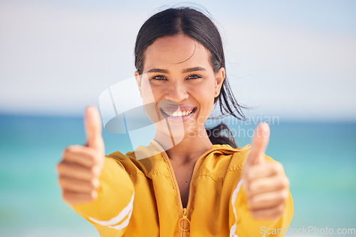 Image of Happy woman, portrait and thumbs up on beach for approval, success or winning in motivation. Outdoor female person smile with like emoji, yes sign or OK for agreement in happiness on the ocean coast