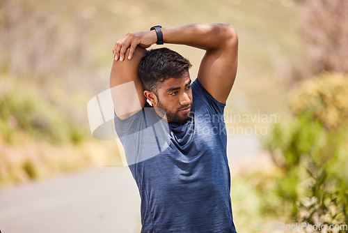 Image of Wellness, man or runner stretching arms on road in training, fitness workout or cardio exercise outdoors. Thinking body flexibility or healthy Indian male athlete in warm up to start running activity