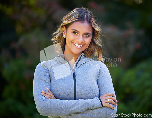 Image of Runner woman, arms crossed and portrait in park, smile and exercise with fitness training in nature. Indian girl, happy and pride for wellness, health or outdoor workout for body, self care or goals