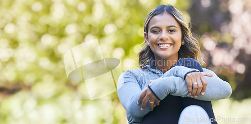 Image of Happy, portrait and a woman outdoor at a park with happiness and a smile for wellness. Young female person in nature for a break or rest after workout, exercise or training with space for health