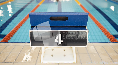 Image of Empty swimming pool, platform and start competition of water sports, race and contest at diving facility. Background of number on jump block at poolside arena to begin exercise, training and fitness