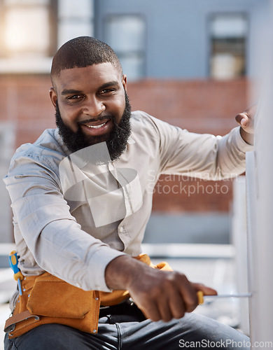 Image of Portrait, engineer and air conditioner install with a black man on a roof for construction or manual labor. Building, engineering and an electrician working on ac repair for maintenance or service