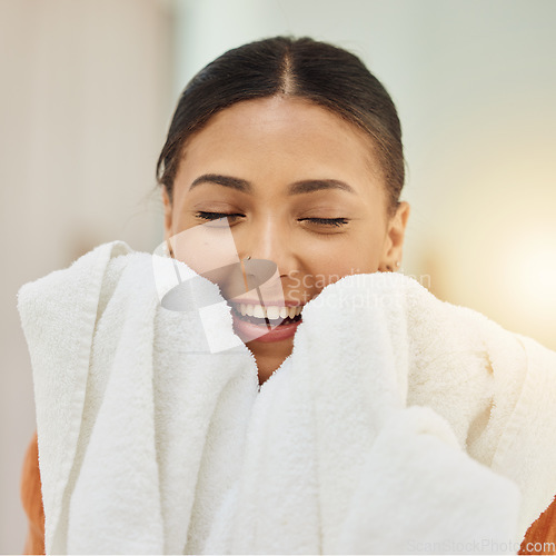 Image of Smile, woman and smell clean towel, fresh scent and fabric after washing cotton or textile for housekeeping in home. Laundry, aroma and happy person with cloth after cleaning for hygiene and wellness