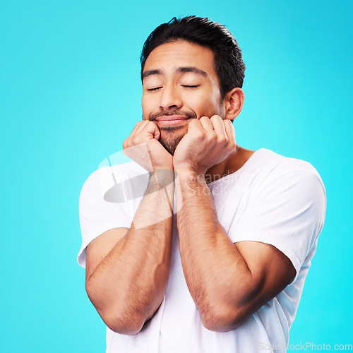 Image of Calm, relax and man face in studio with sleeping with memory, smile and thinking to remember. Isolated, blue background and happy male model with eyes closed for rest and nap feeling thoughtful