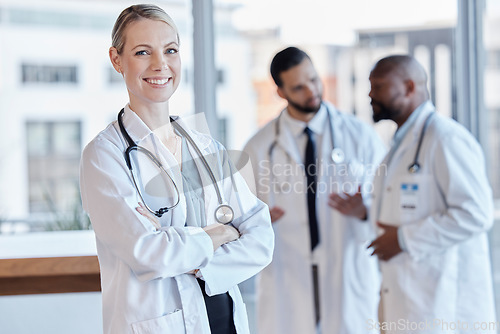 Image of Woman, happy and portrait of a doctor with arms crossed in a hospital for medical service. Smile, pride and a female nurse or surgeon with confidence while working at a clinic and leadership