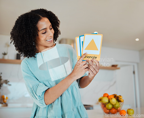 Image of Learning, education and cards with a happy mother in her home for teaching, growth or development. Smile, school and a female parent or tutor in the kitchen for a private lesson on shape or color