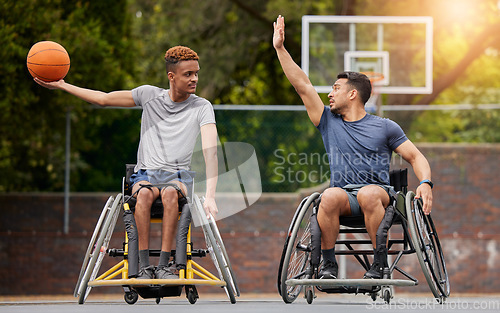 Image of Sports, basketball and men in wheelchair on court for training, exercise and workout on outdoor park. Fitness, team and male people with disability play with ball for competition, practice and games